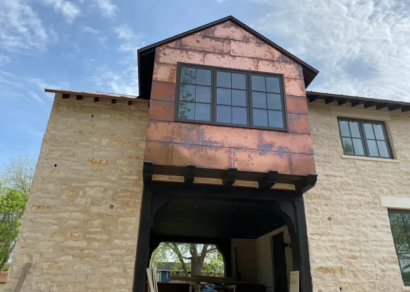 Copper metal panel facade on a stone building for Roof Repair in Litchfield